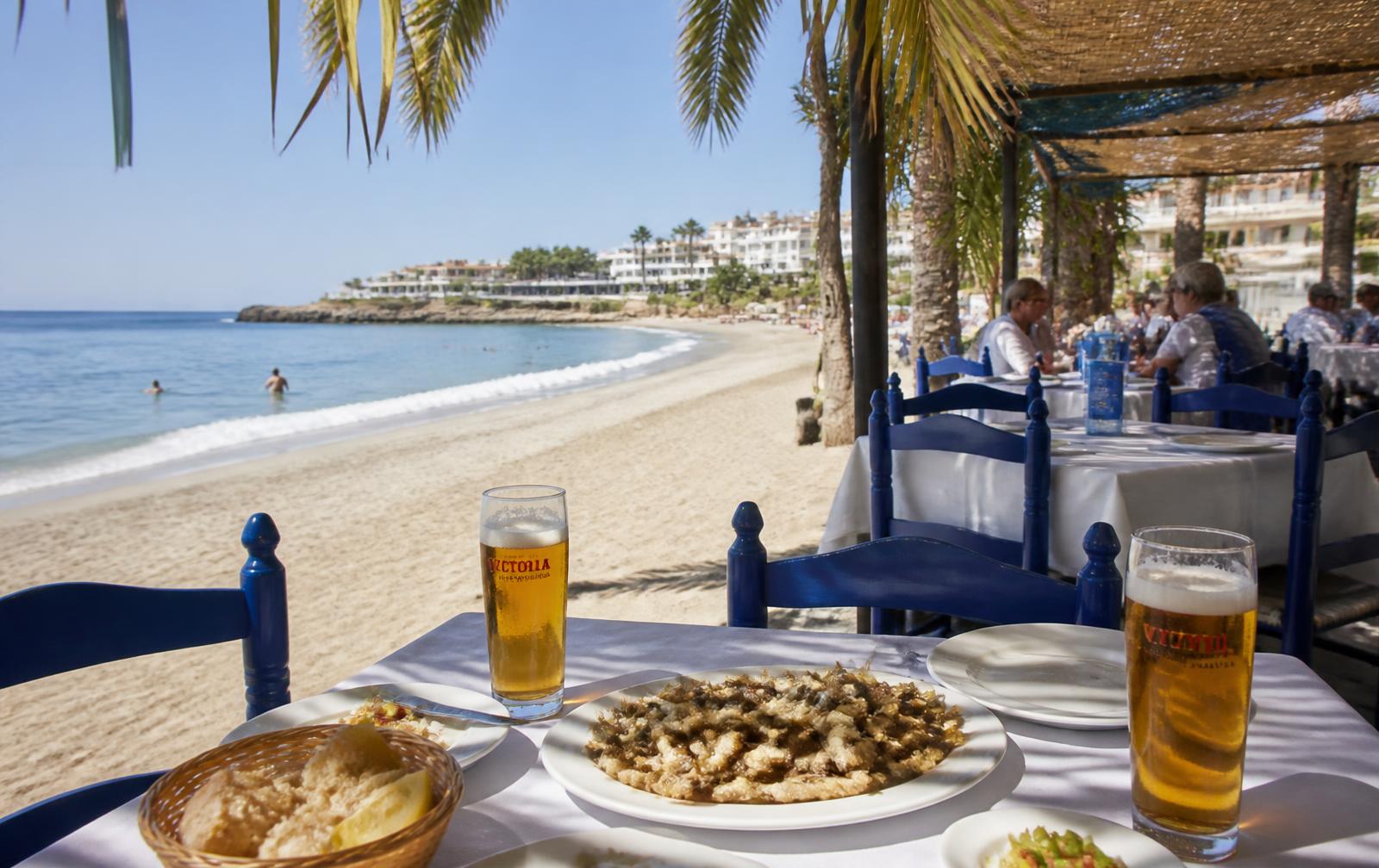 Beach chiringuito terrace on the sand with fried fish and sea views