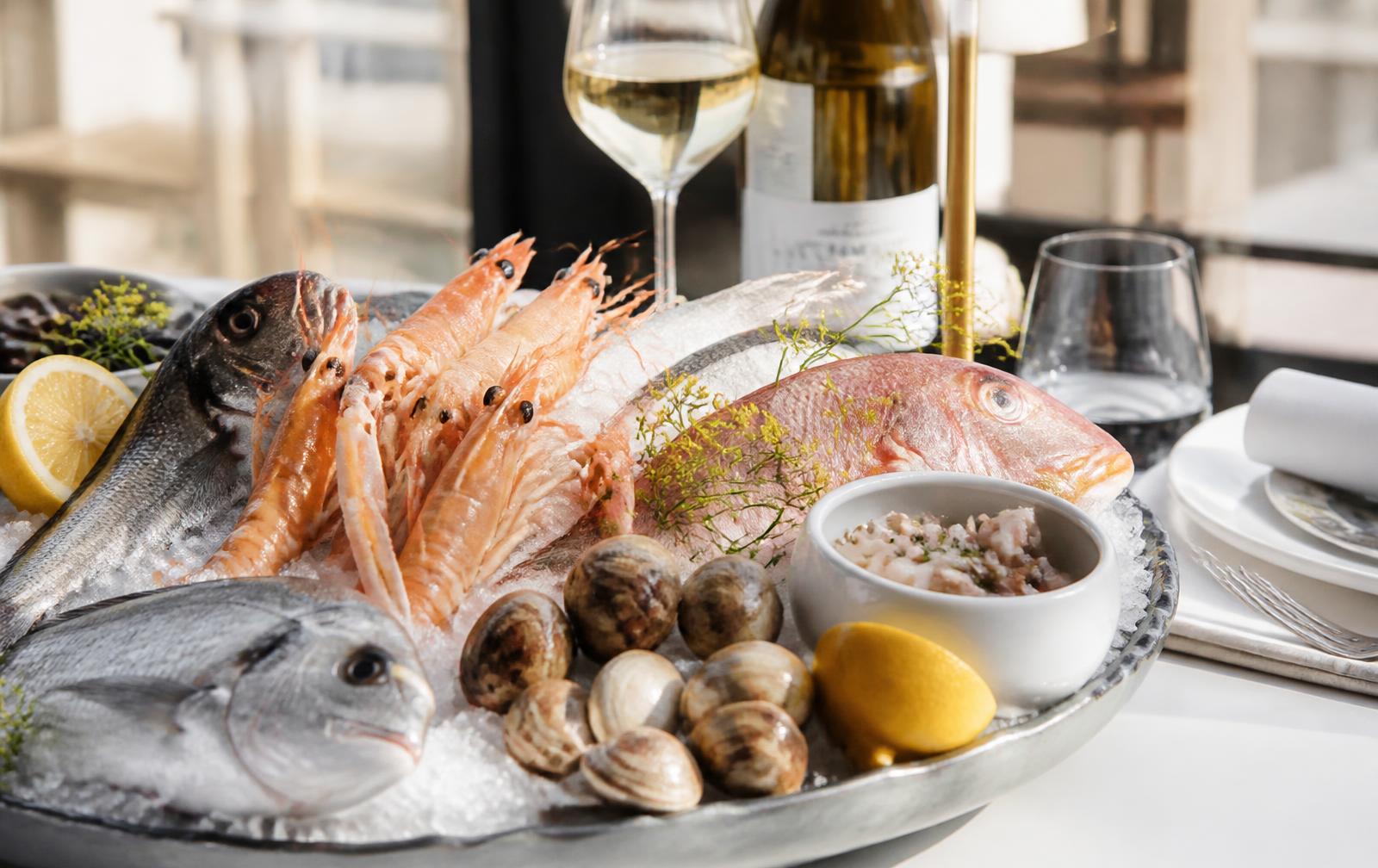 Fresh Mediterranean fish and shellfish on ice at a seafood restaurant table